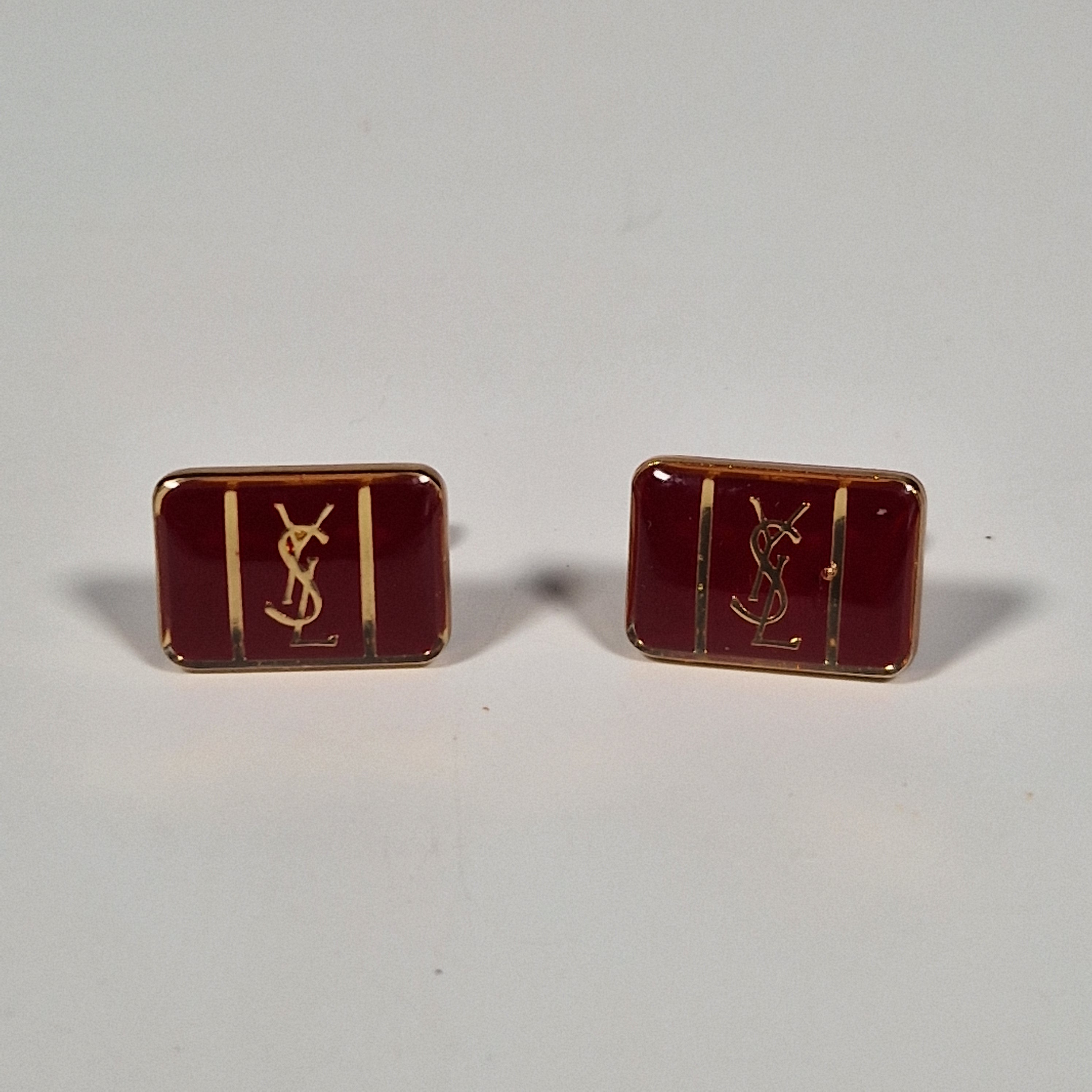 Yves Saint laurent a pair of cufflinks and a tie pin