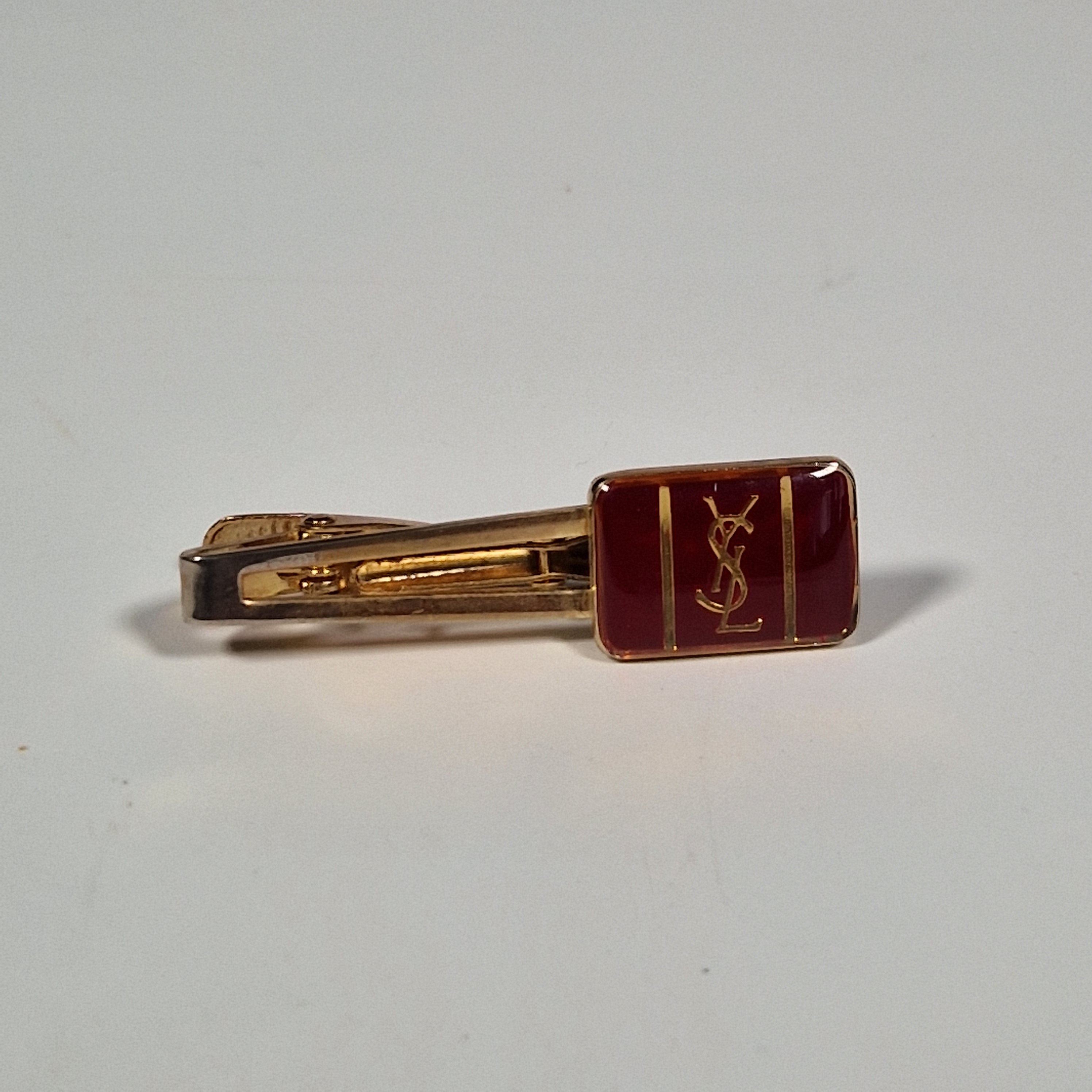 Yves Saint laurent a pair of cufflinks and a tie pin