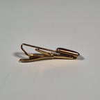 Yves Saint laurent a pair of cufflinks and a tie pin