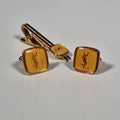Yves Saint laurent a pair of cufflinks and a tie pin