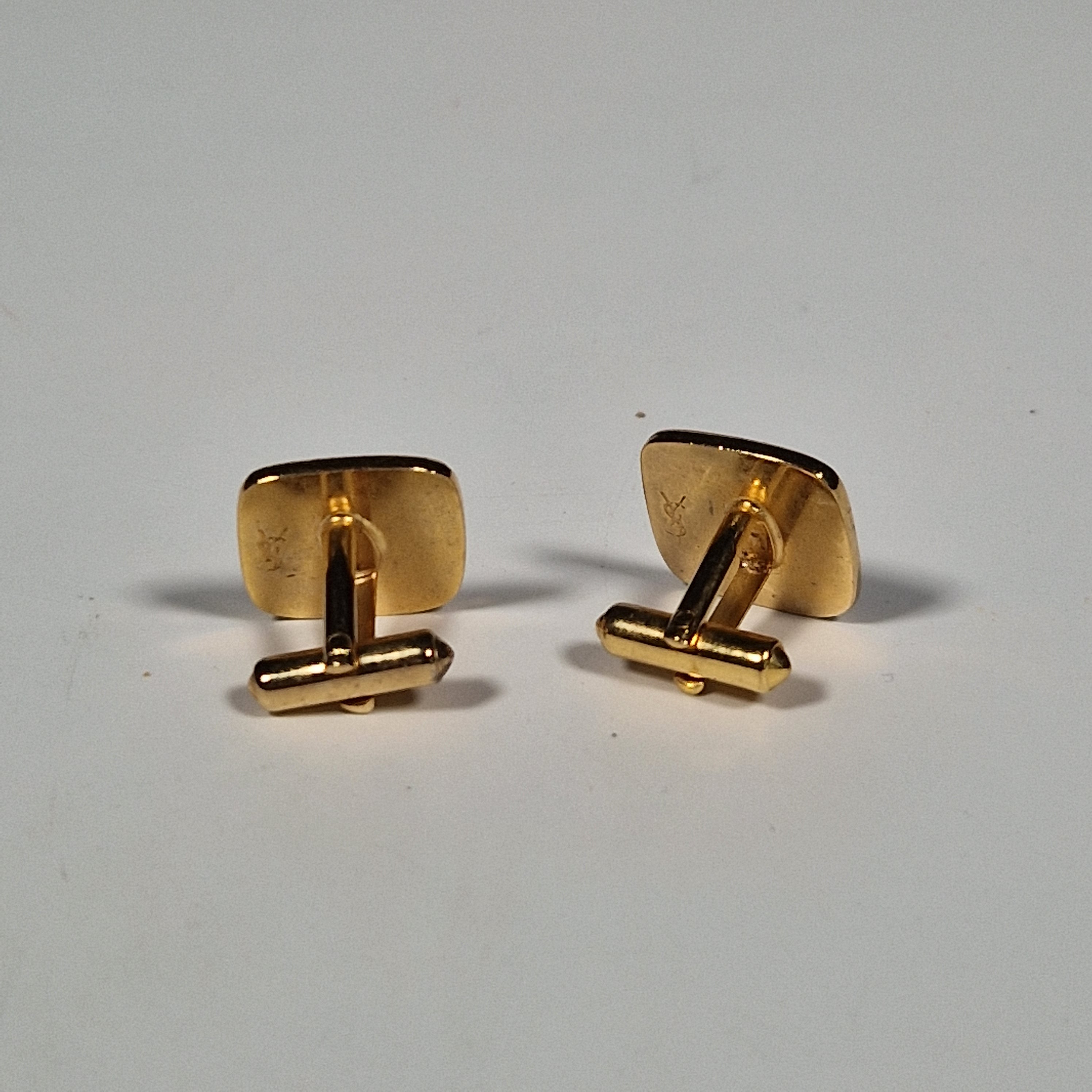 Yves Saint laurent a pair of cufflinks and a tie pin