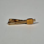 Yves Saint laurent a pair of cufflinks and a tie pin