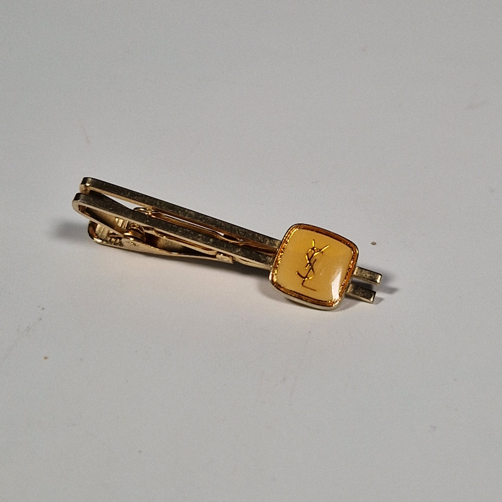Yves Saint laurent a pair of cufflinks and a tie pin