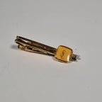 Yves Saint laurent a pair of cufflinks and a tie pin