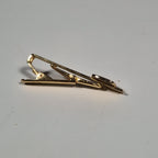 Yves Saint laurent a pair of cufflinks and a tie pin