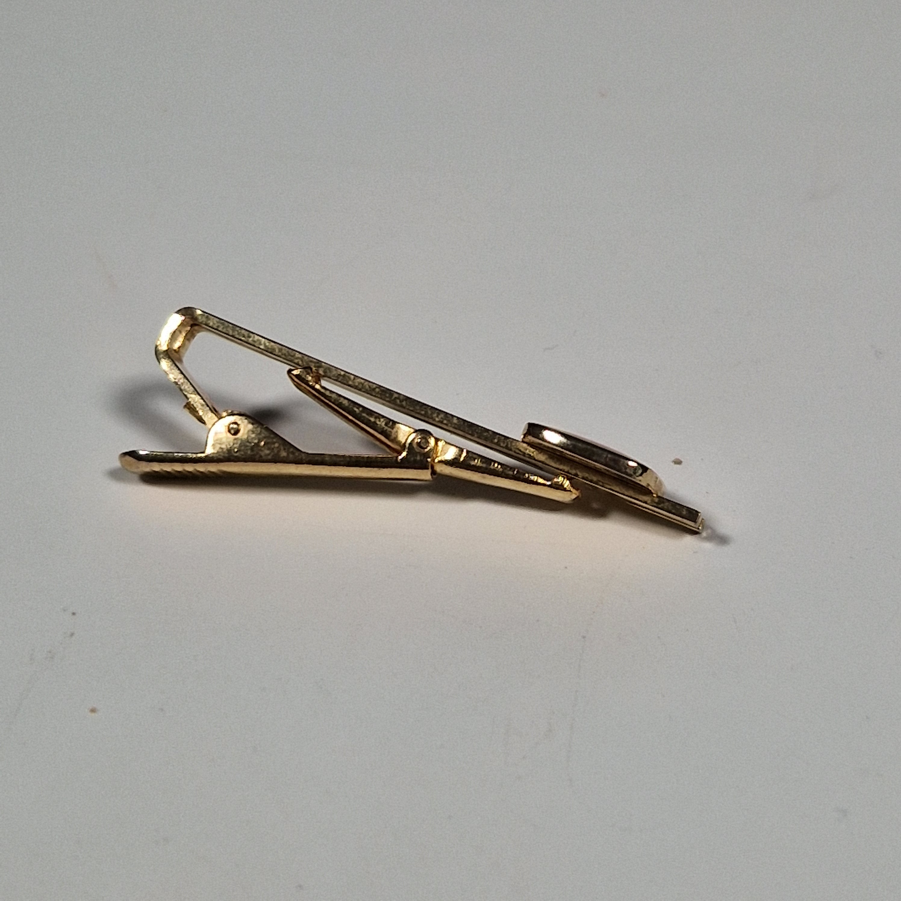 Yves Saint laurent a pair of cufflinks and a tie pin