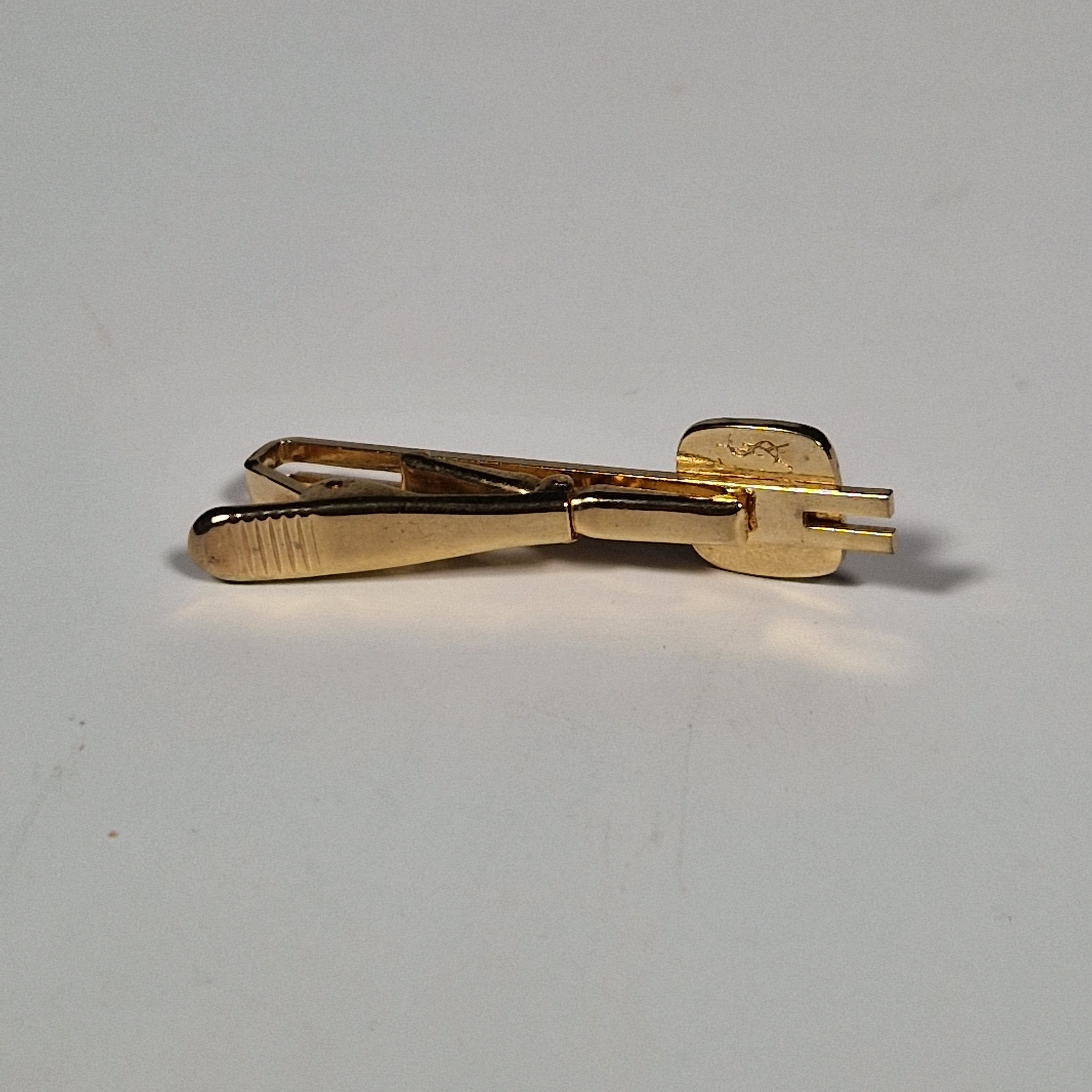 Yves Saint laurent a pair of cufflinks and a tie pin