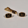 Yves Saint Laurent a pair of cufflinks and a tie pin