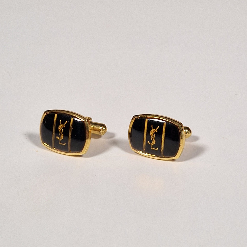 Yves Saint Laurent a pair of cufflinks and a tie pin