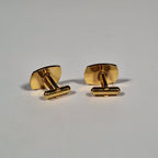 Yves Saint Laurent a pair of cufflinks and a tie pin