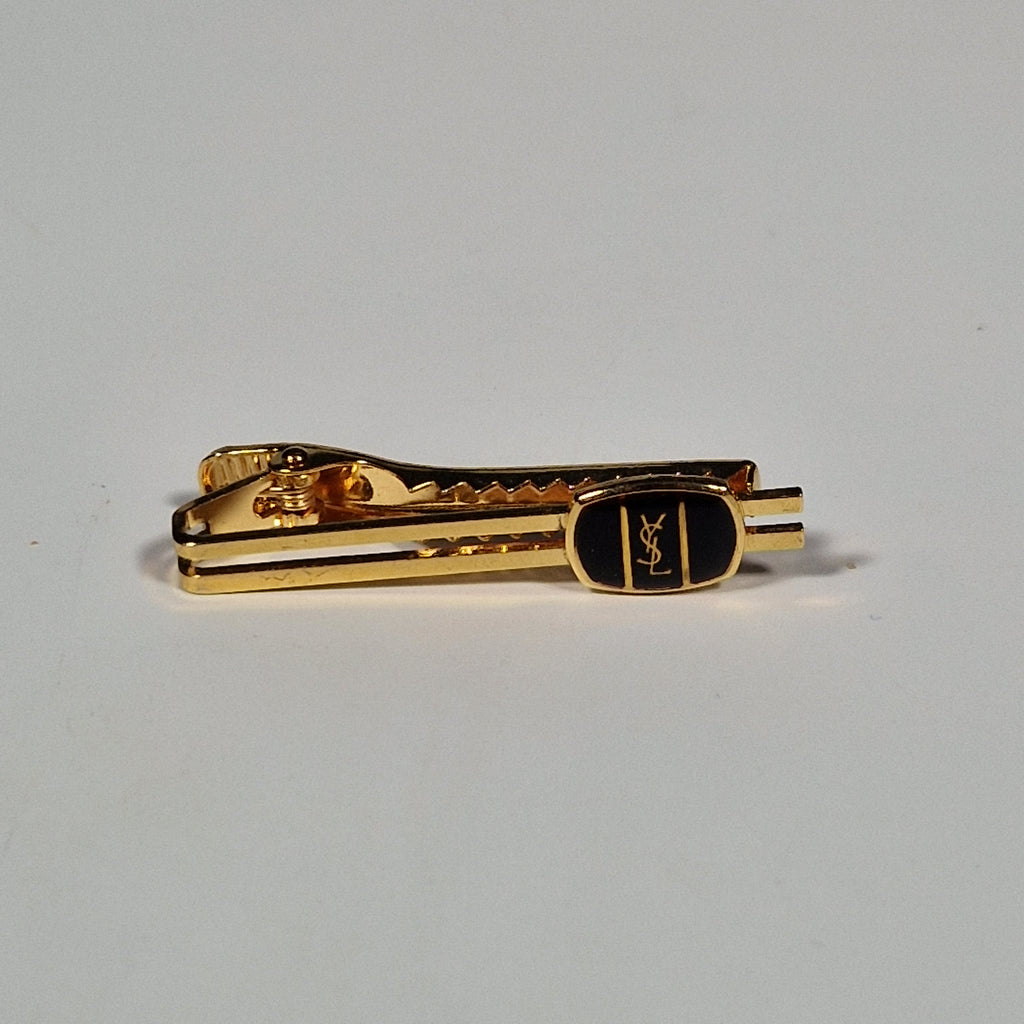 Yves Saint Laurent a pair of cufflinks and a tie pin