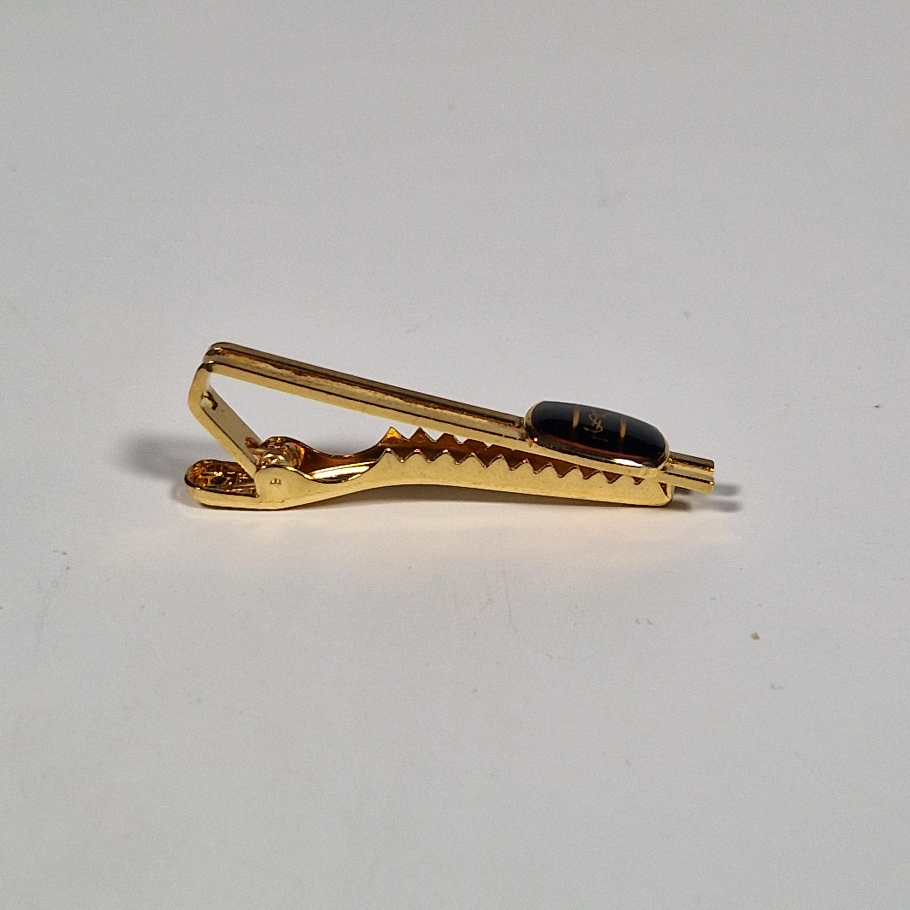 Yves Saint Laurent a pair of cufflinks and a tie pin