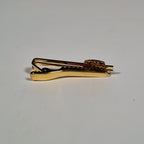 Yves Saint Laurent a pair of cufflinks and a tie pin