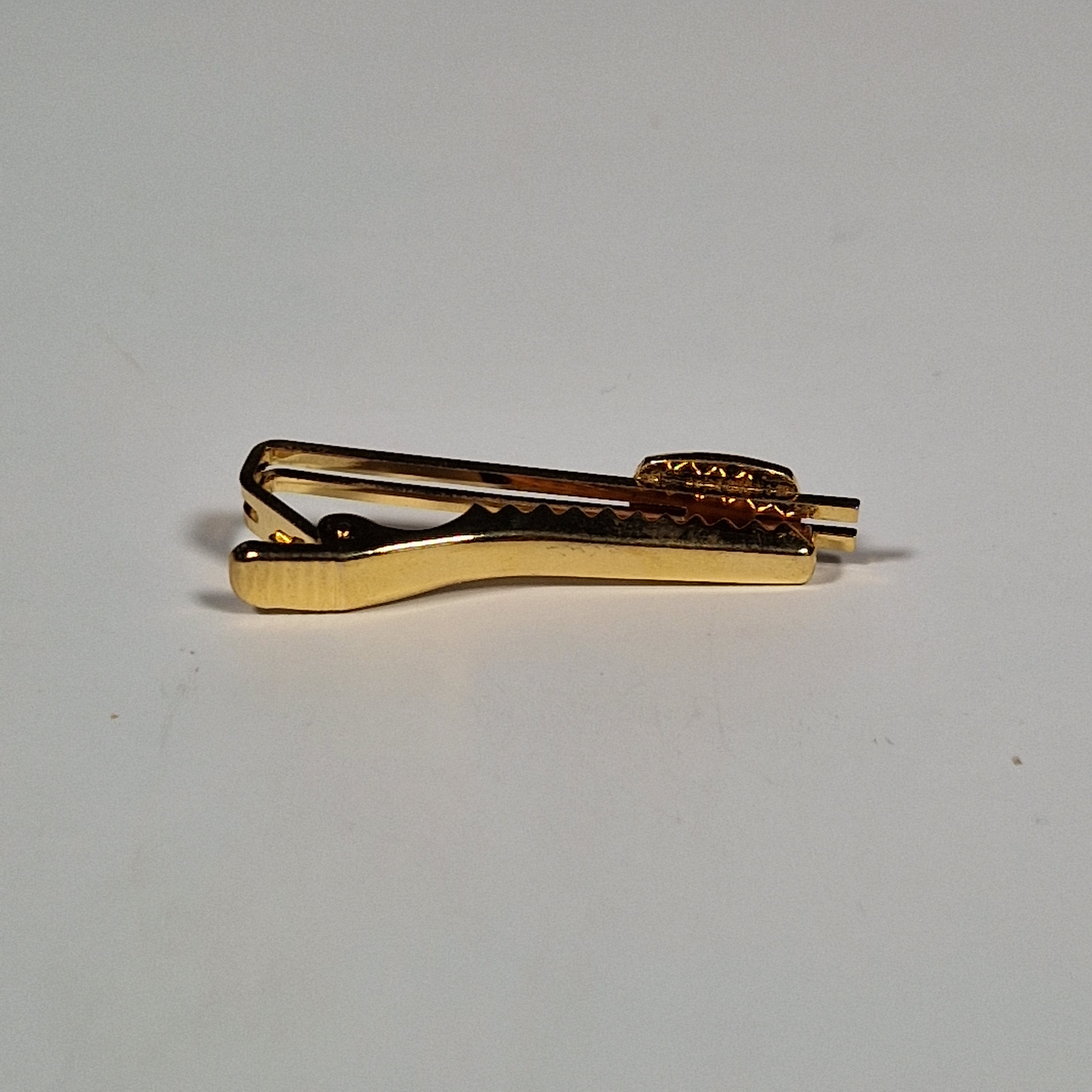 Yves Saint Laurent a pair of cufflinks and a tie pin