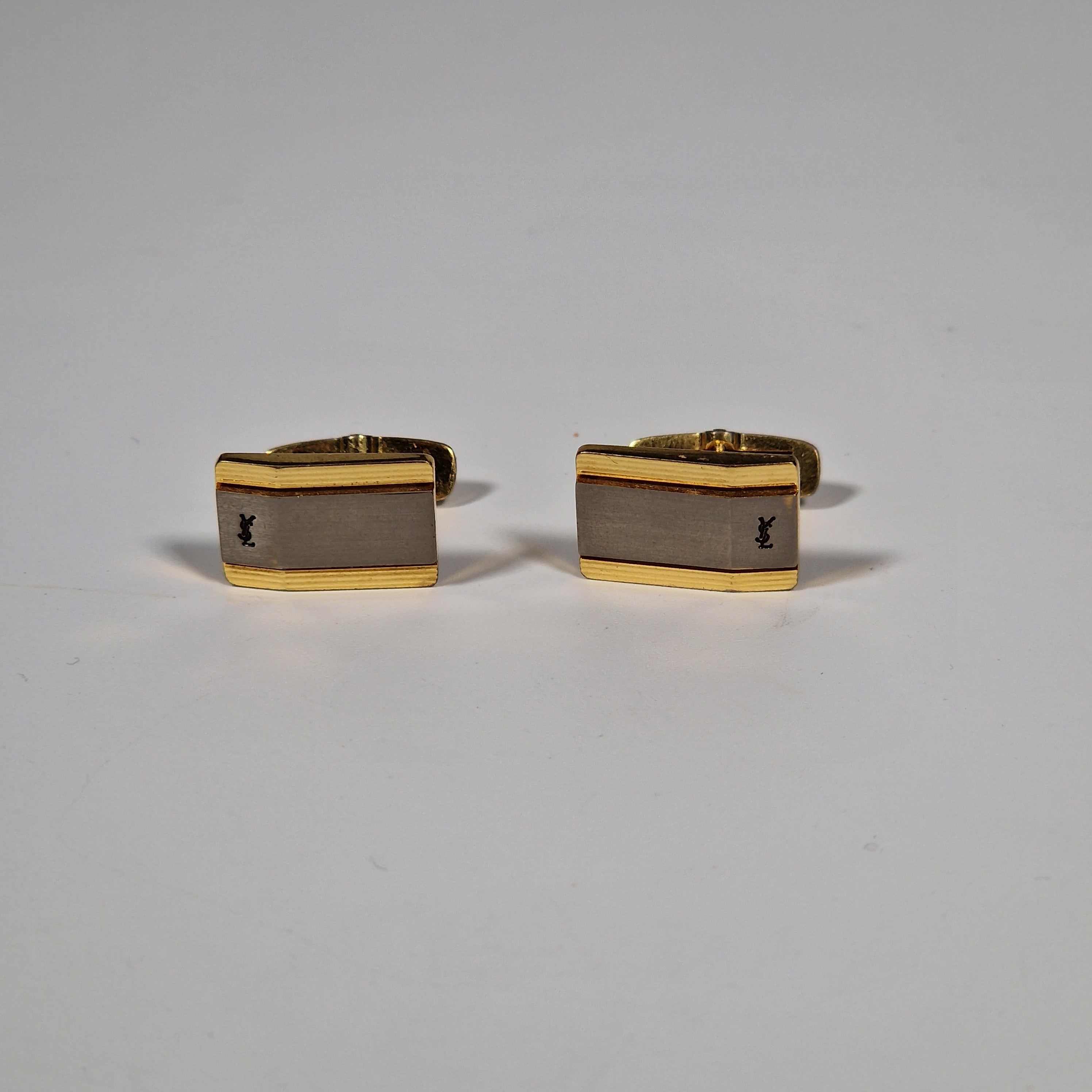 Yves Saint Laurent a pair of cufflinks.