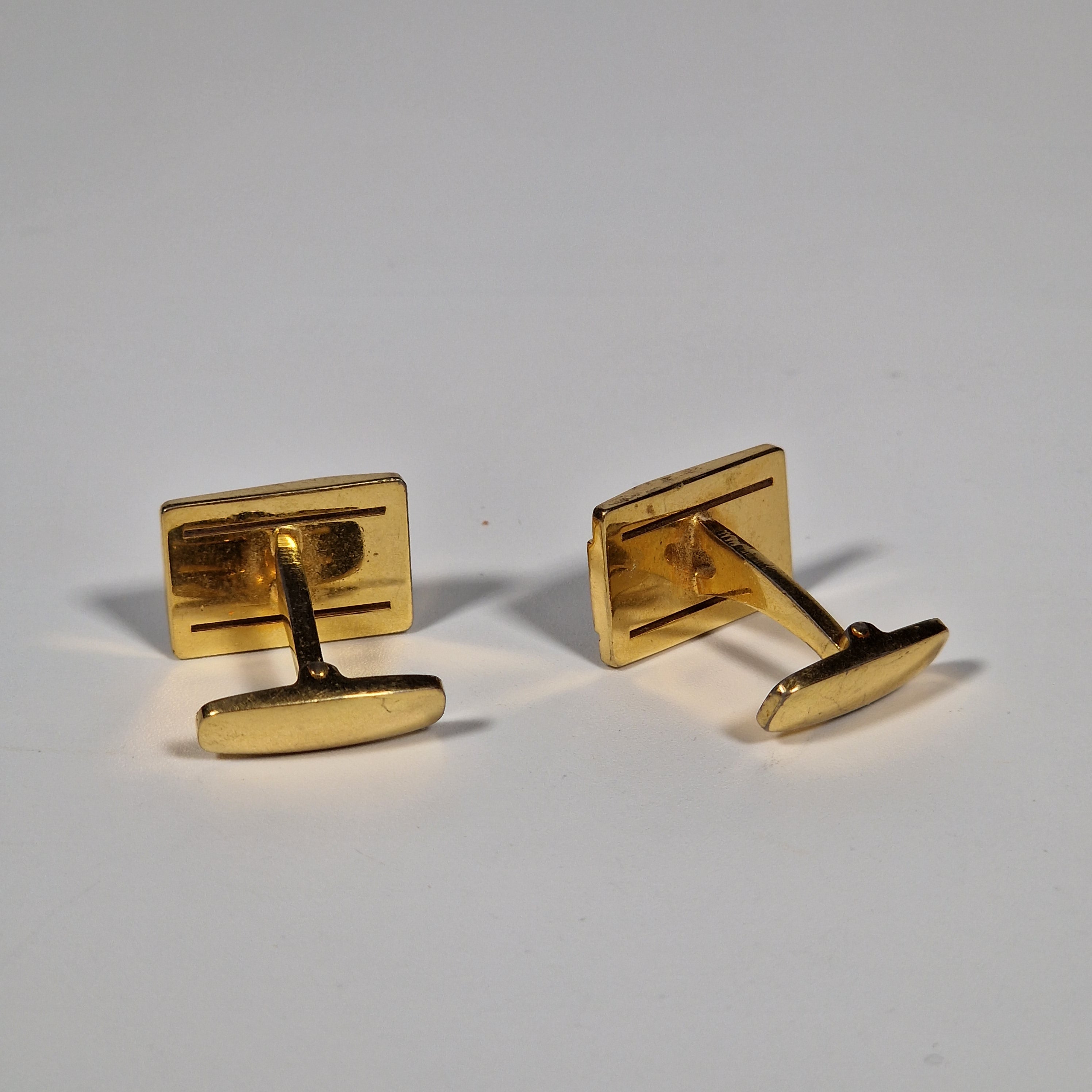 Yves Saint Laurent a pair of cufflinks.