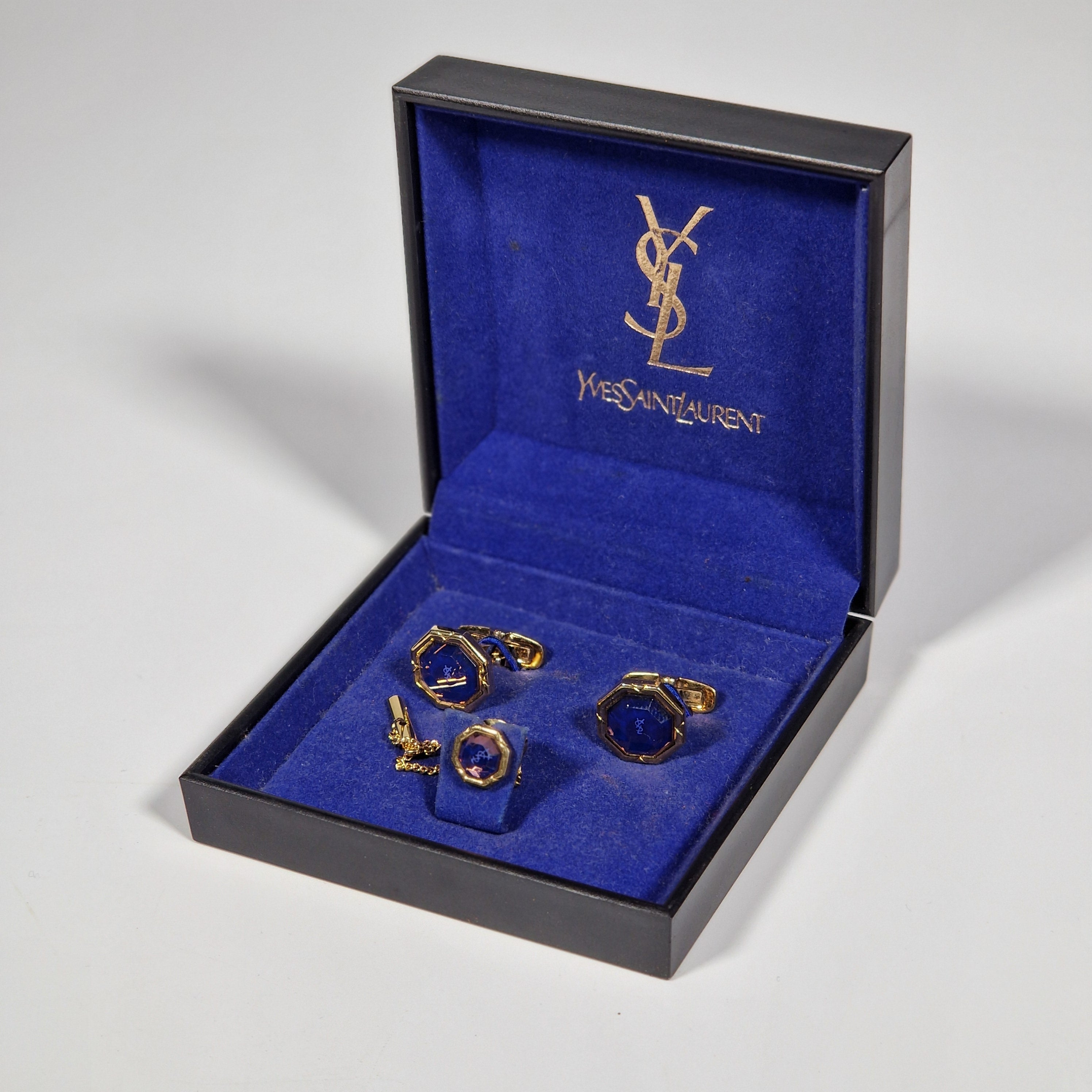 Yves Saint Laurent a pair of cufflinks and a tie pin with box.