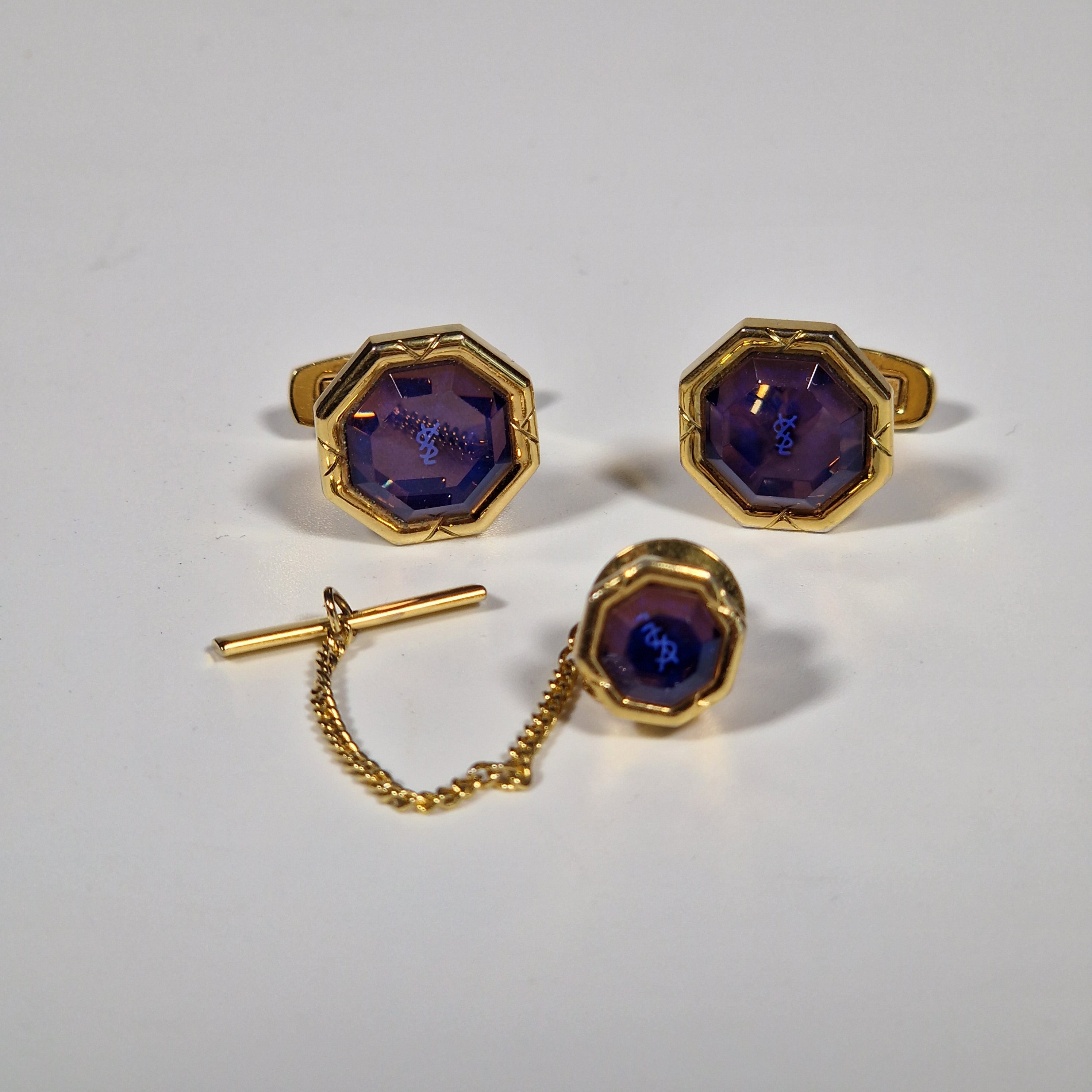 Yves Saint Laurent a pair of cufflinks and a tie pin with box.