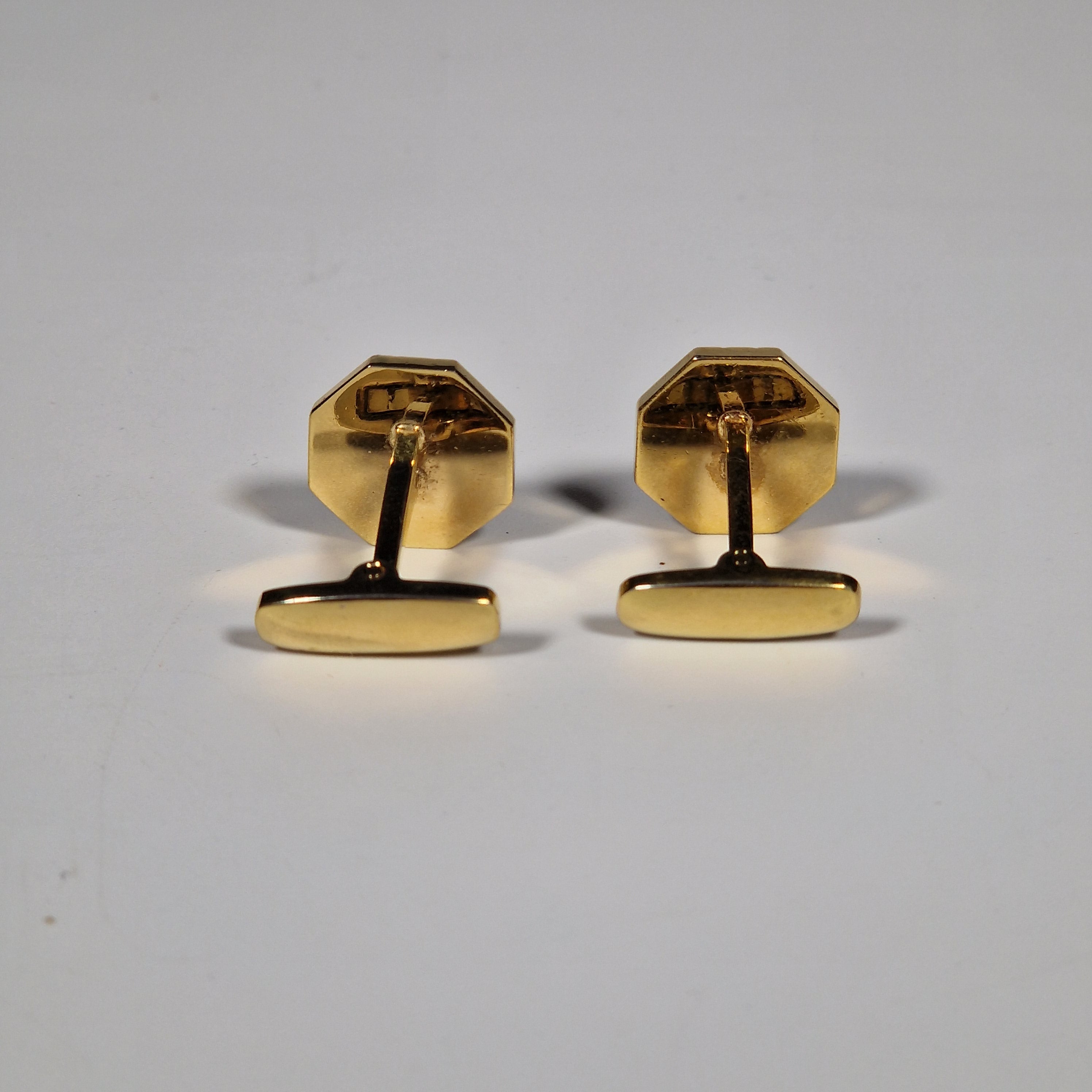 Yves Saint Laurent a pair of cufflinks and a tie pin with box.