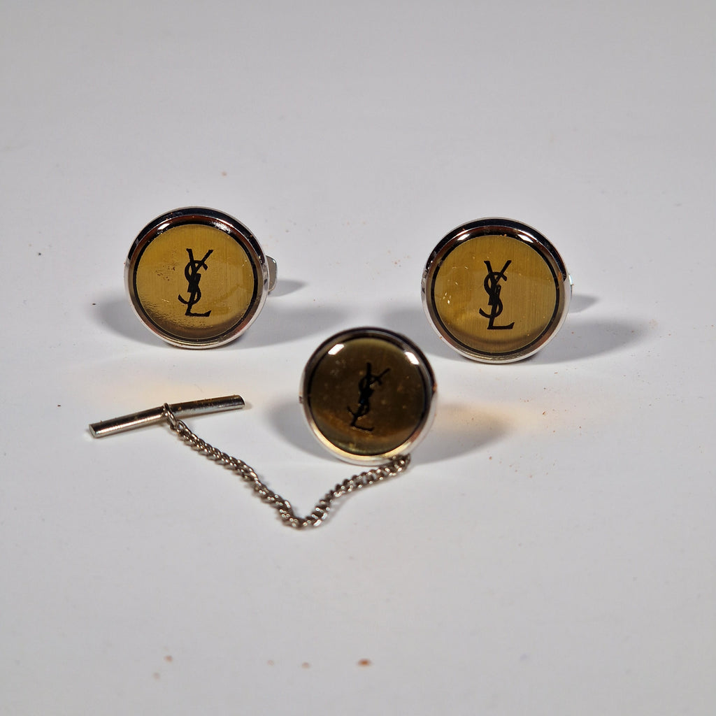 Yves Saint Laurent a pair of cufflinks and a tie pin with box.
