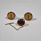 Yves Saint Laurent a pair of cufflinks and a tie pin with box.