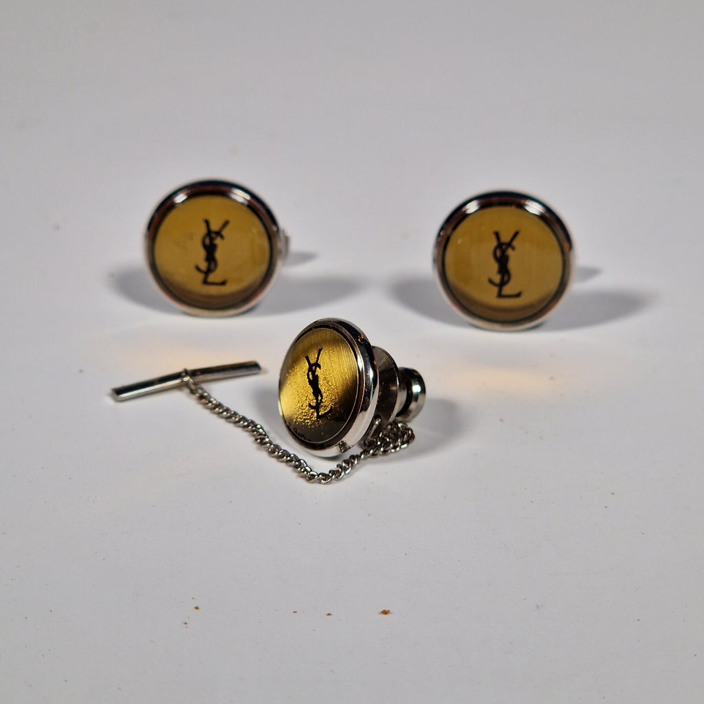 Yves Saint Laurent a pair of cufflinks and a tie pin with box.
