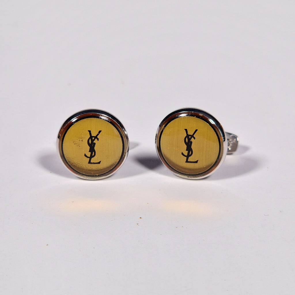 Yves Saint Laurent a pair of cufflinks and a tie pin with box.