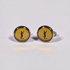 Yves Saint Laurent a pair of cufflinks and a tie pin with box.