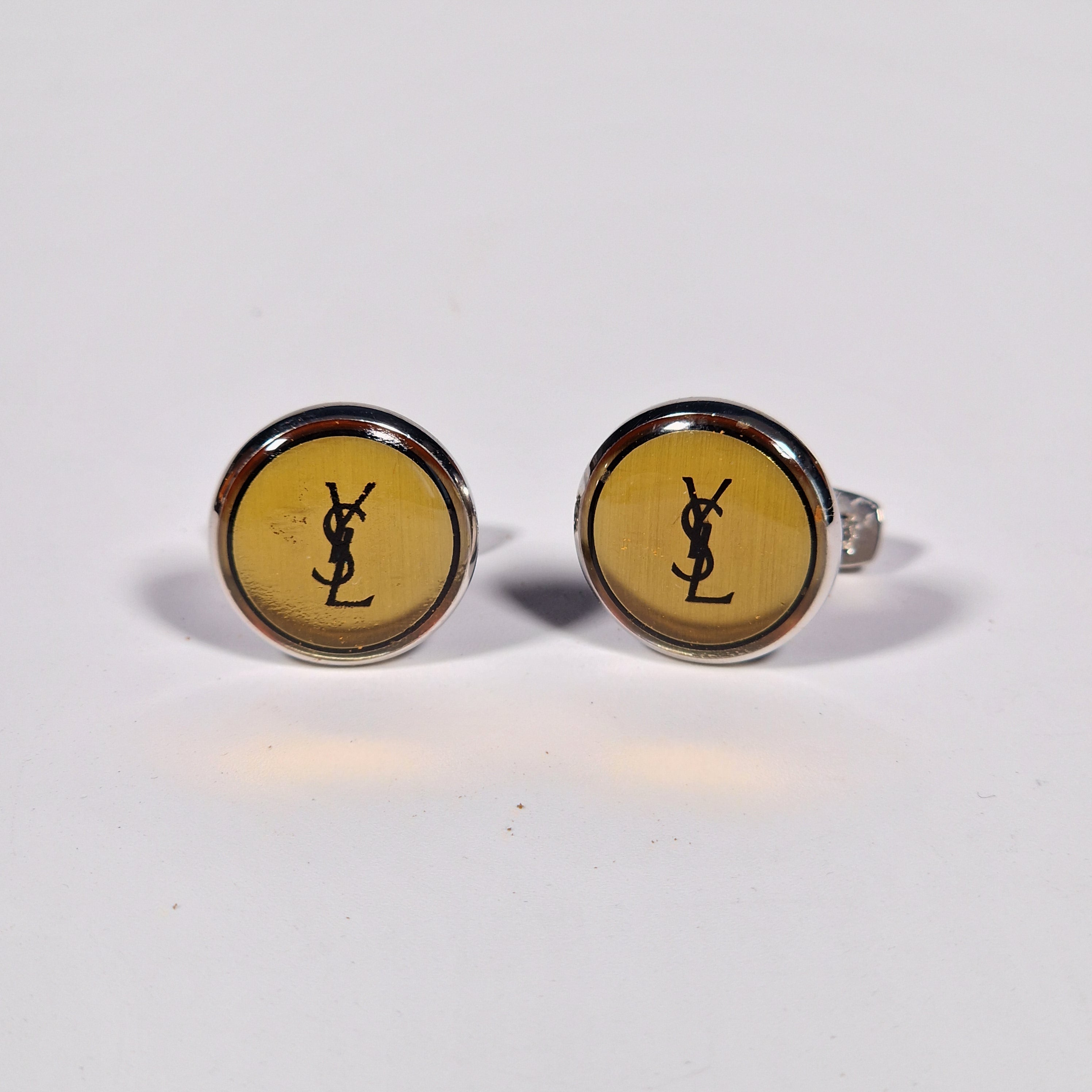Yves Saint Laurent a pair of cufflinks and a tie pin with box.