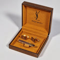 Yves Saint Laurent a pair of cufflinks and a tie pin with box.