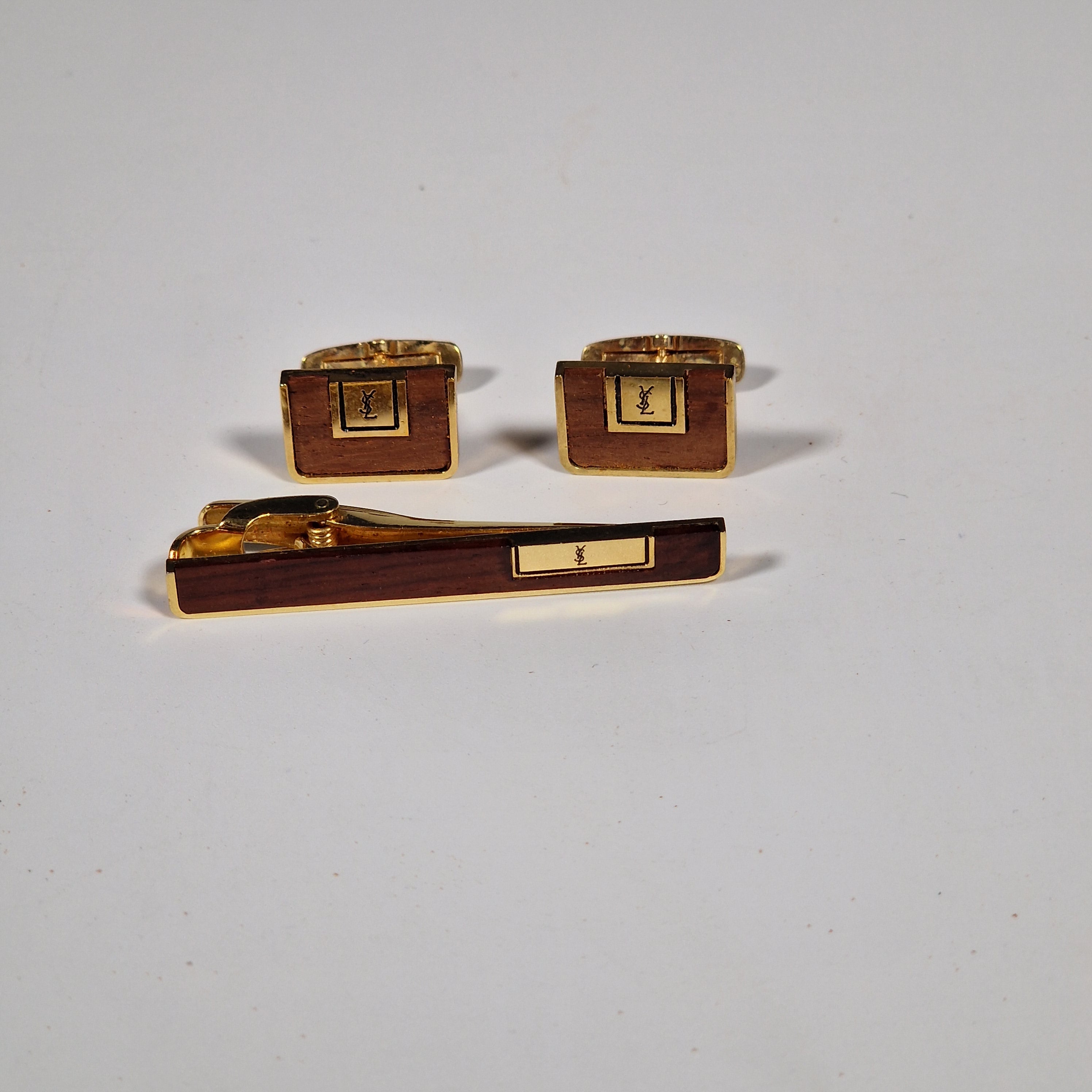 Yves Saint Laurent a pair of cufflinks and a tie pin with box.