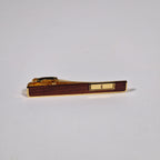 Yves Saint Laurent a pair of cufflinks and a tie pin with box.