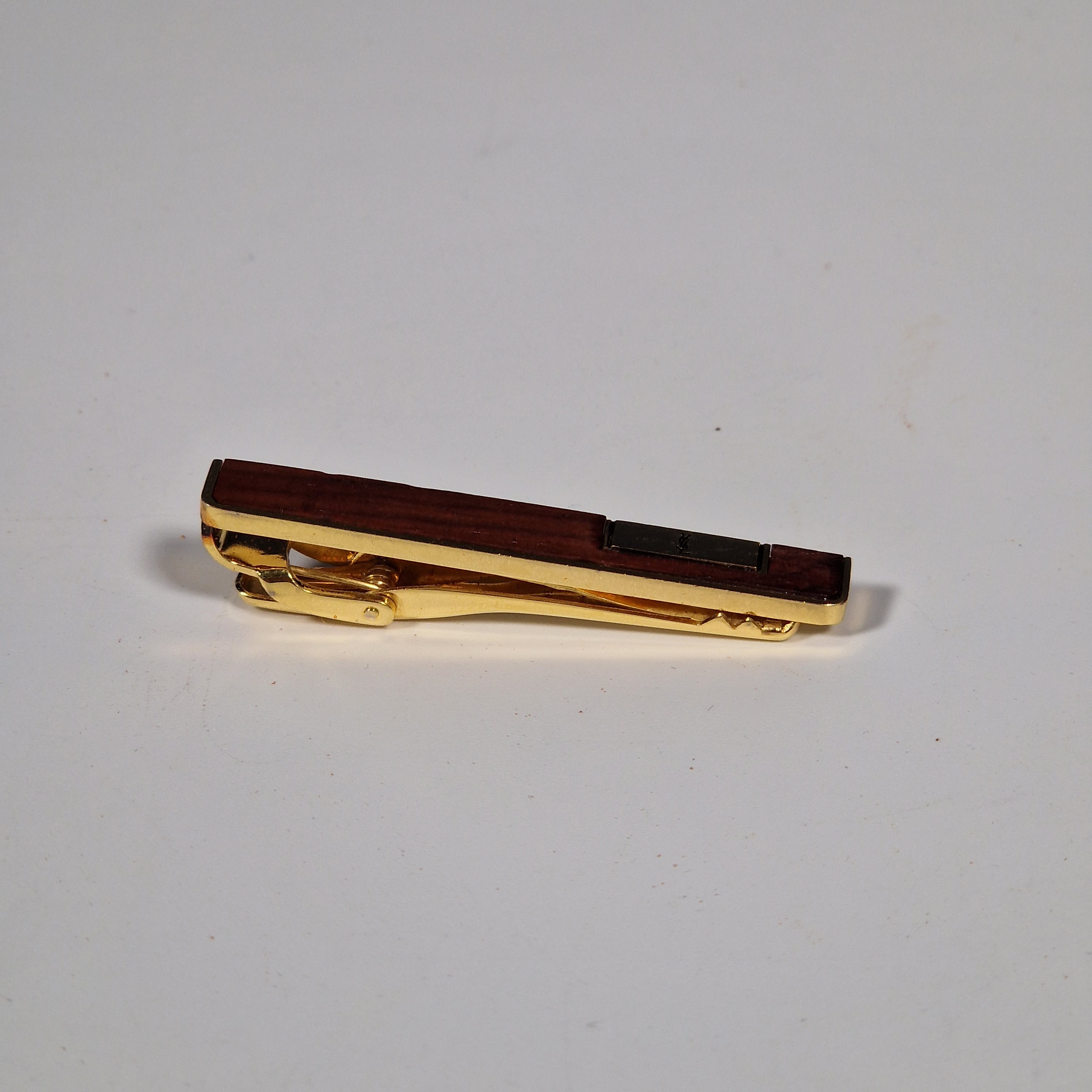 Yves Saint Laurent a pair of cufflinks and a tie pin with box.