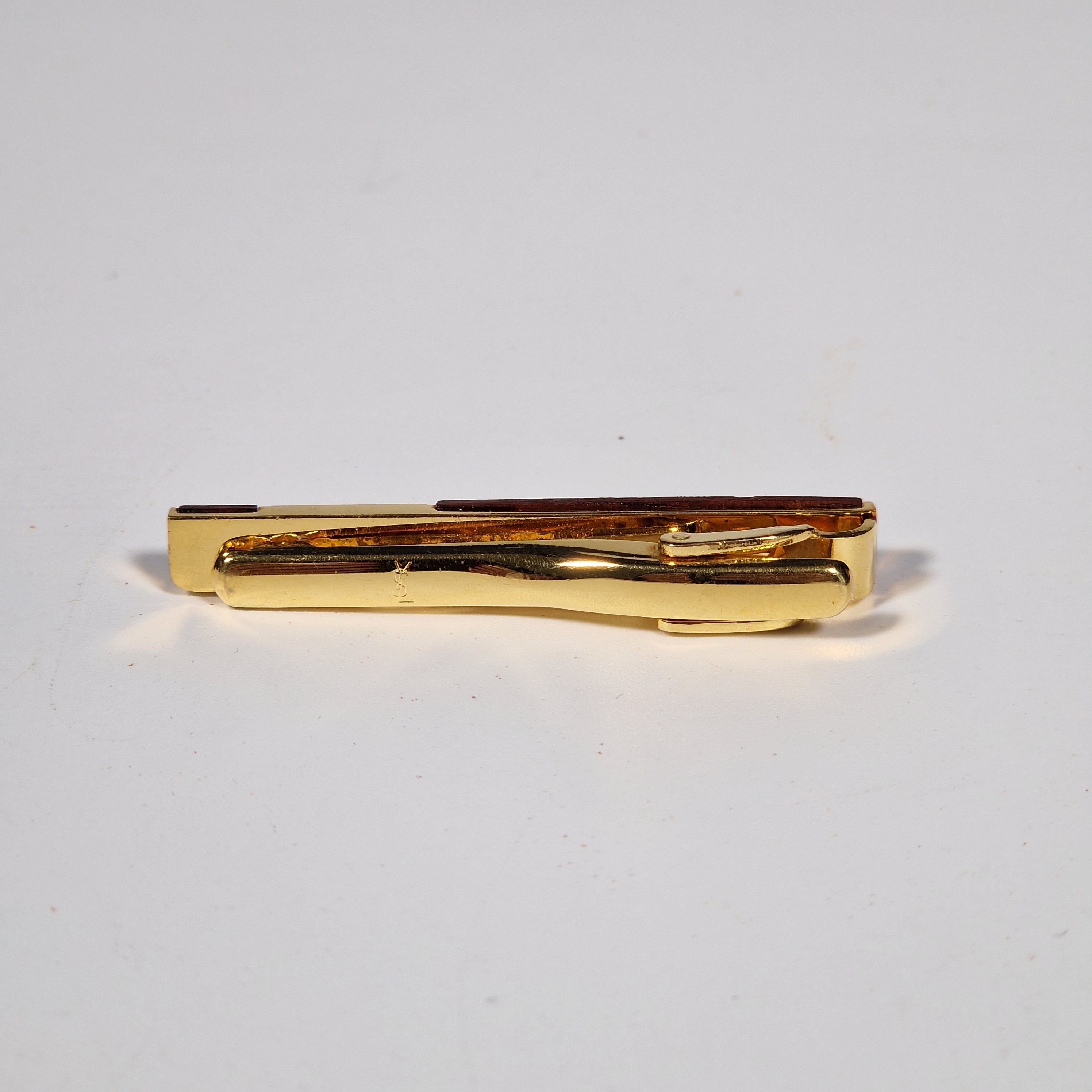 Yves Saint Laurent a pair of cufflinks and a tie pin with box.