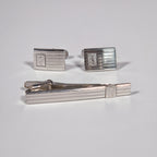 Yves Saint Laurent a pair of cufflinks and a tie pin with box.