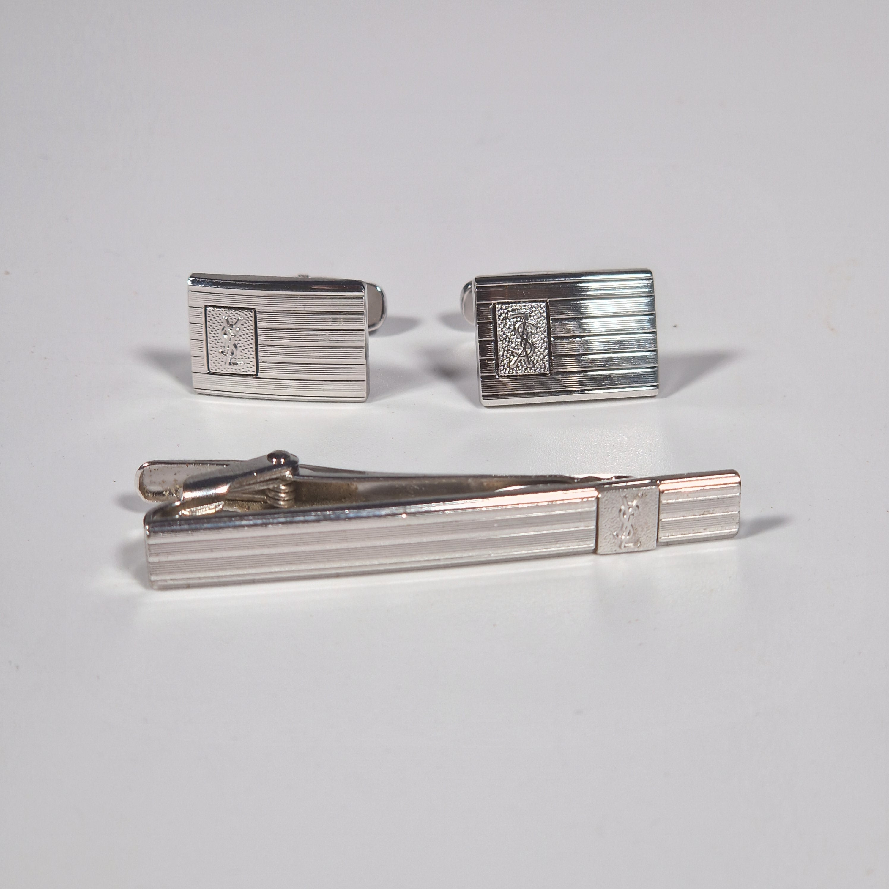 Yves Saint Laurent a pair of cufflinks and a tie pin with box.