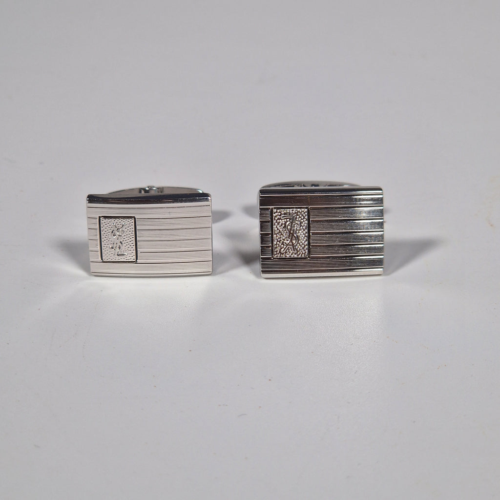 Yves Saint Laurent a pair of cufflinks and a tie pin with box.