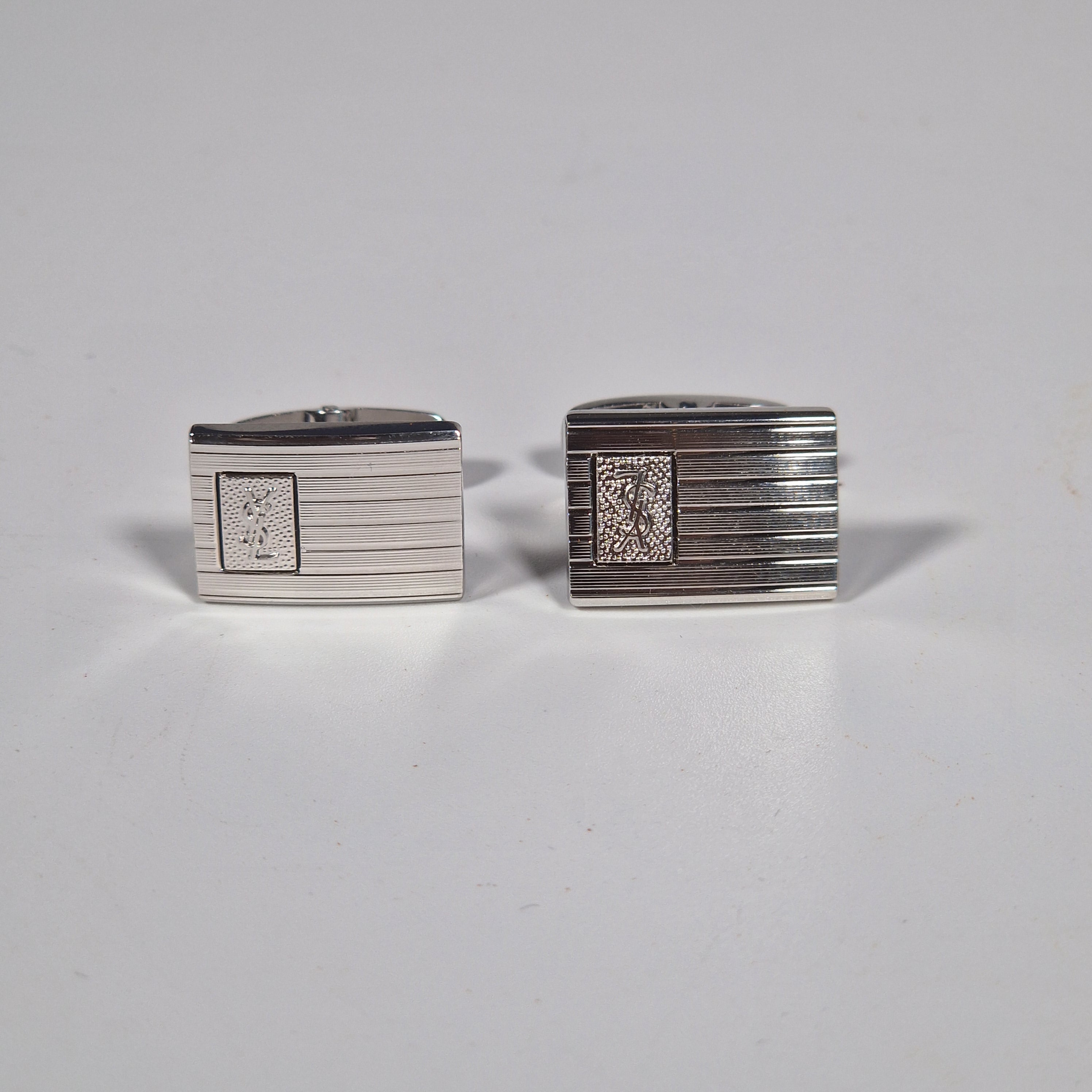 Yves Saint Laurent a pair of cufflinks and a tie pin with box.