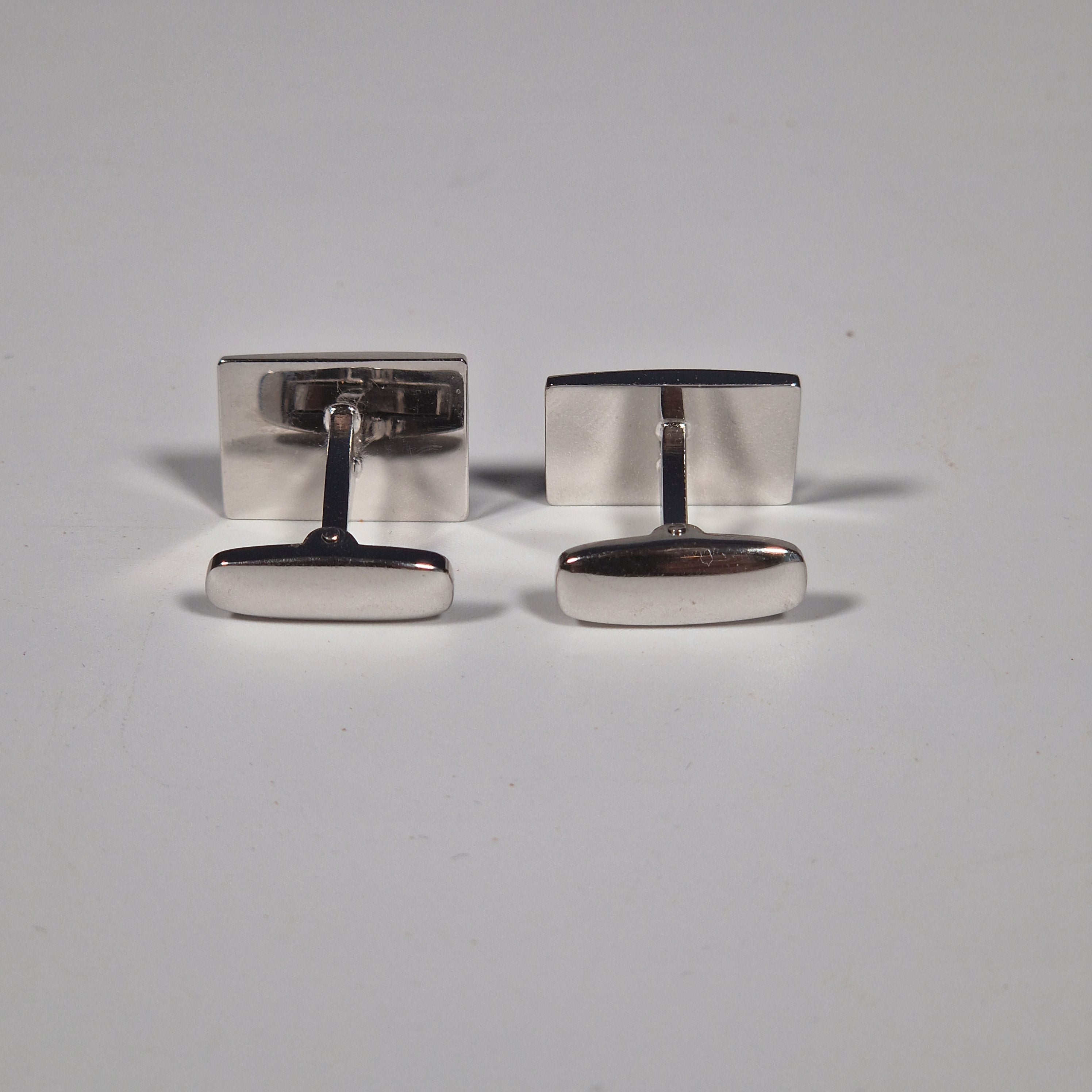 Yves Saint Laurent a pair of cufflinks and a tie pin with box.