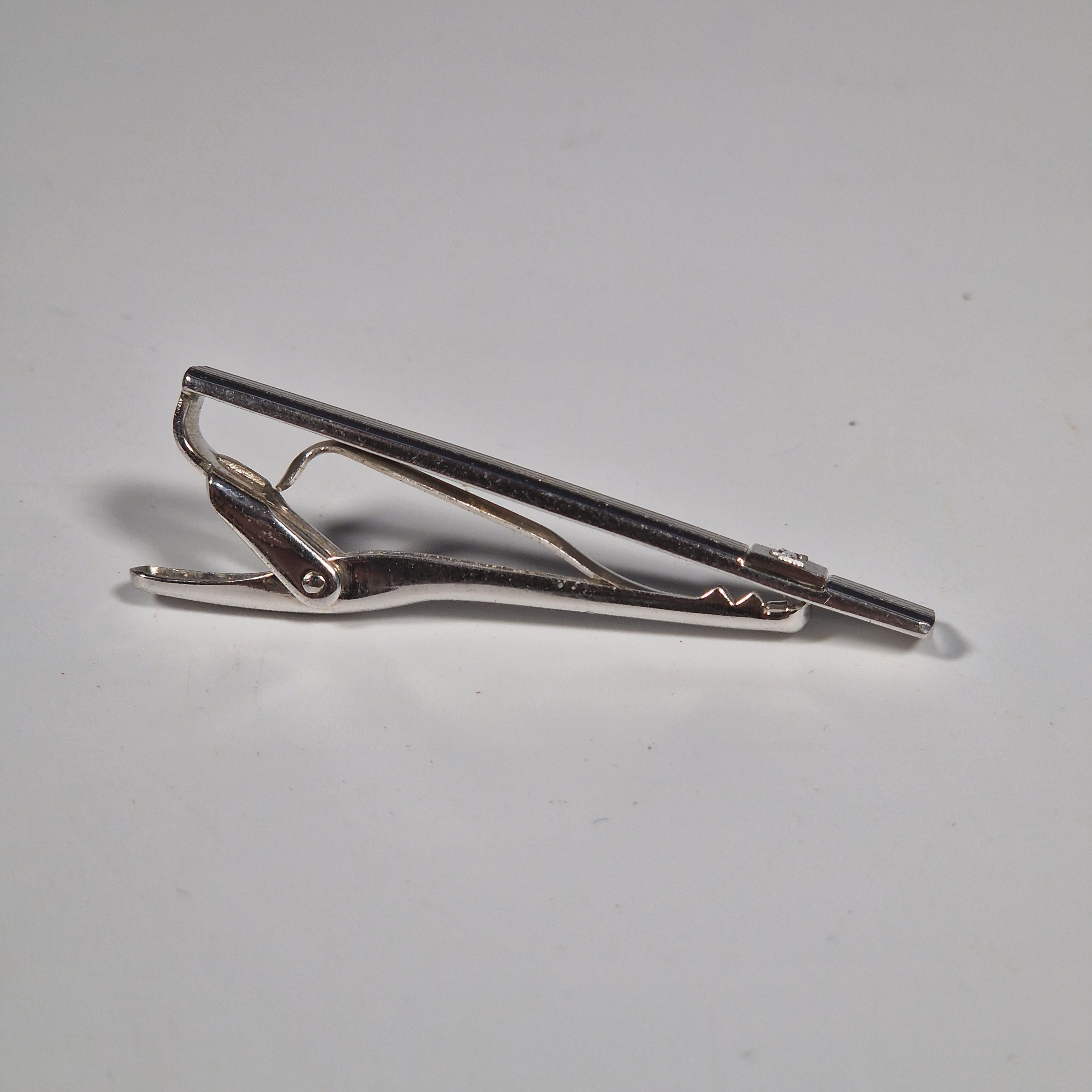 Yves Saint Laurent a pair of cufflinks and a tie pin with box.