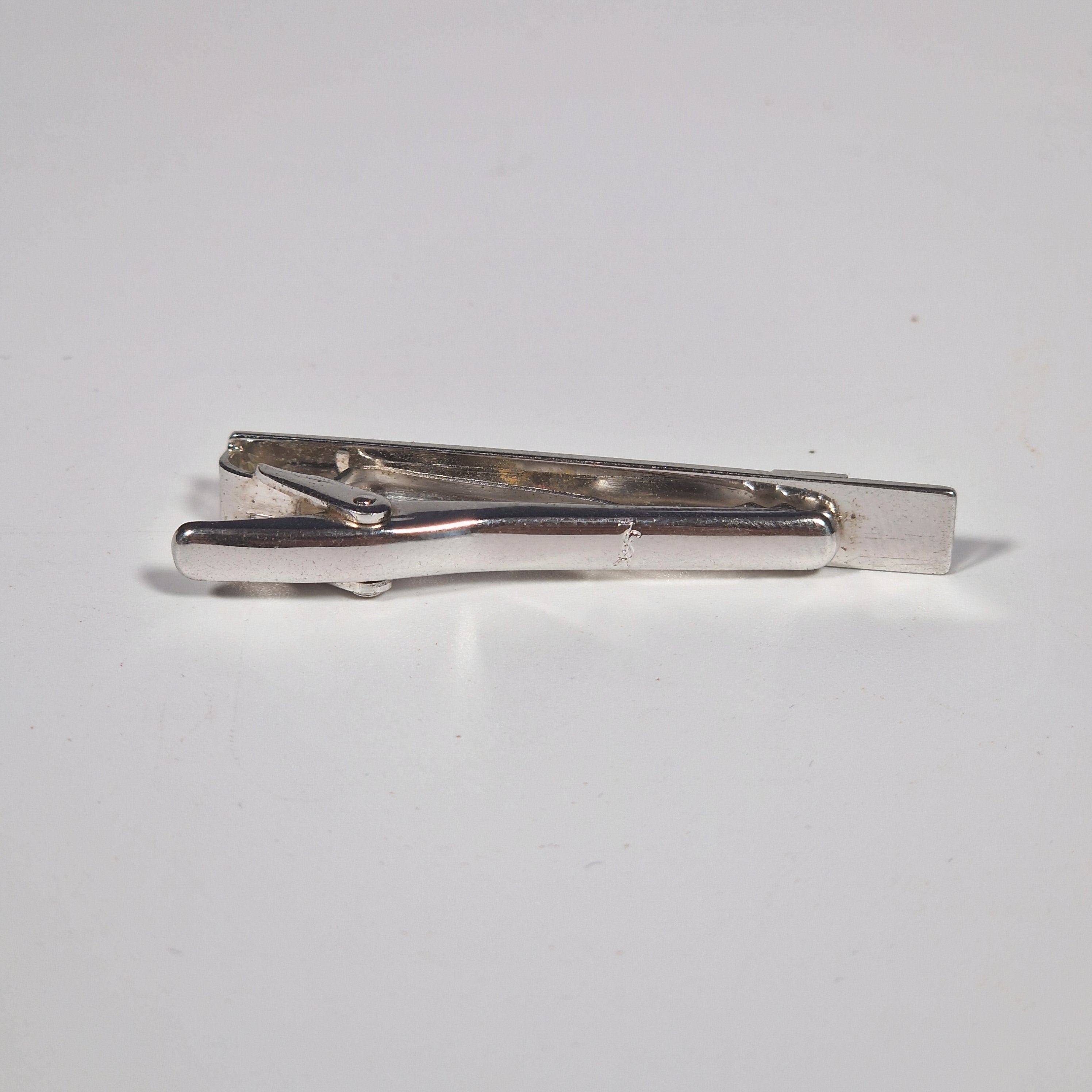 Yves Saint Laurent a pair of cufflinks and a tie pin with box.