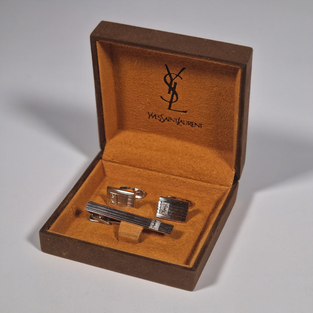 Yves Saint Laurent a pair of cufflinks and a tie pin with box.