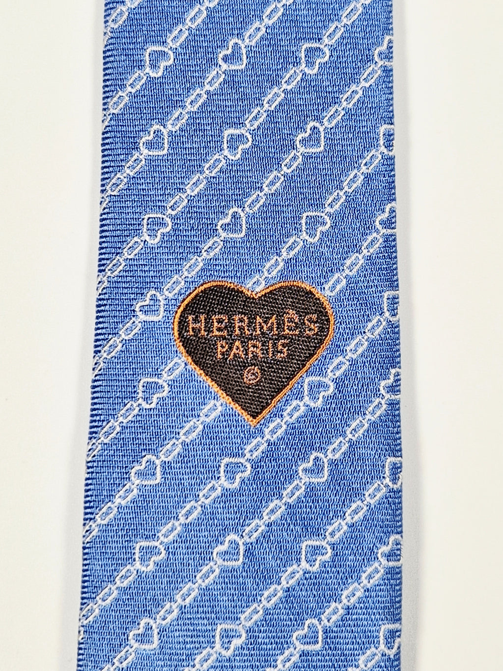 Hermès silk tie blue chain and hearts pattern 339360 T