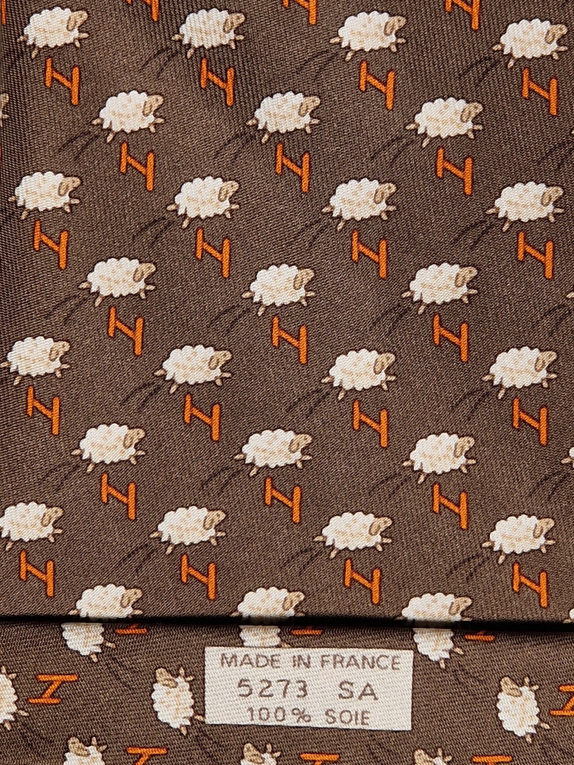 Hermès silk tie brown whimsical jumping sheep and H pattern 5273 SA