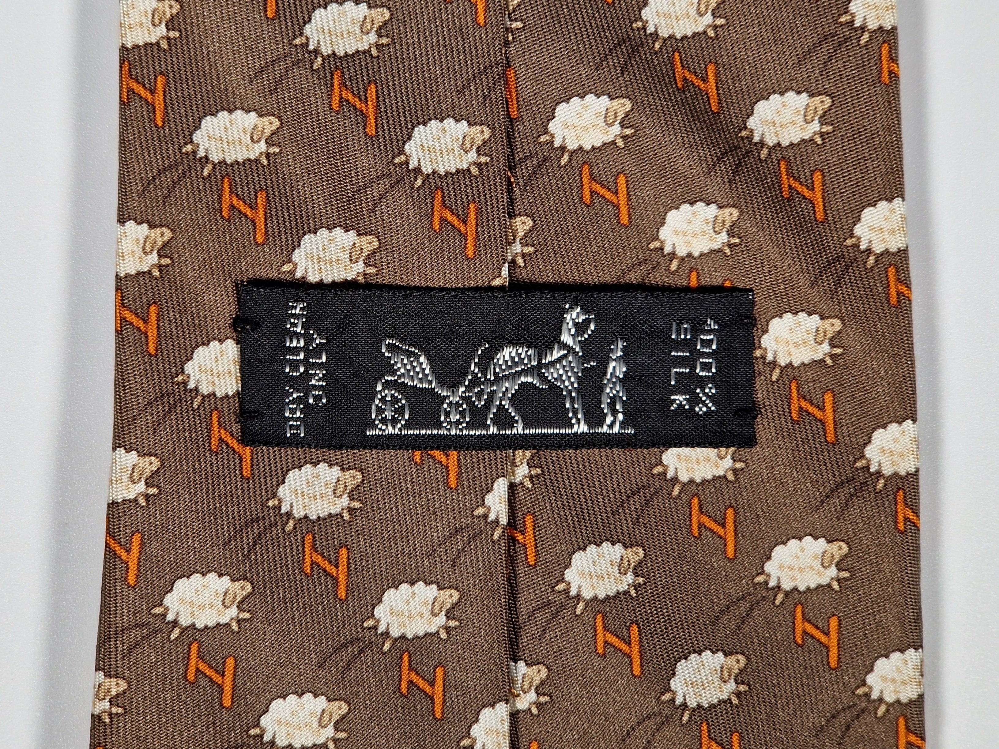 Hermès silk tie brown whimsical jumping sheep and H pattern 5273 SA