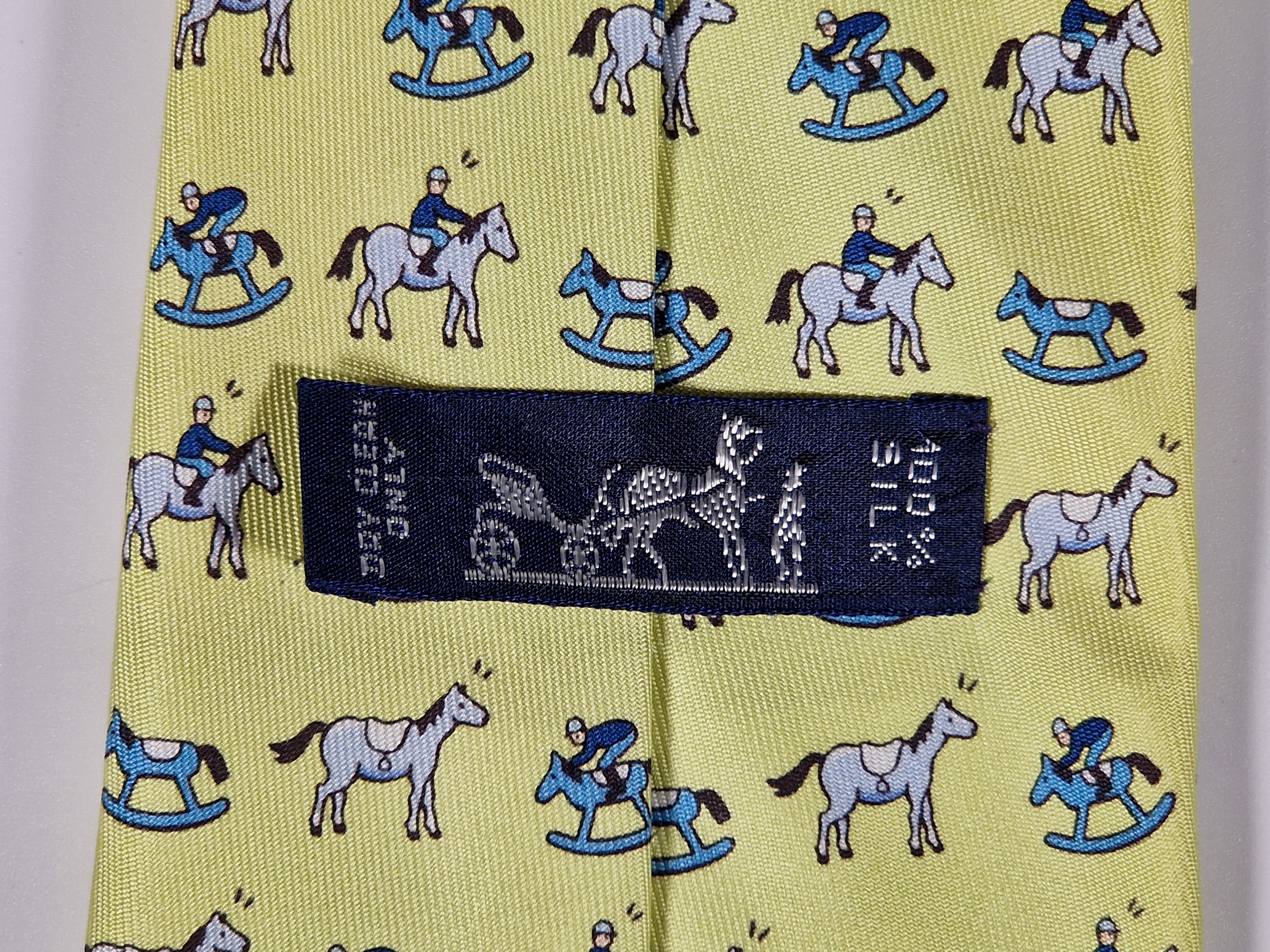 Hermès silk tie yellow horse, jockey and rocking horse 5313 TA