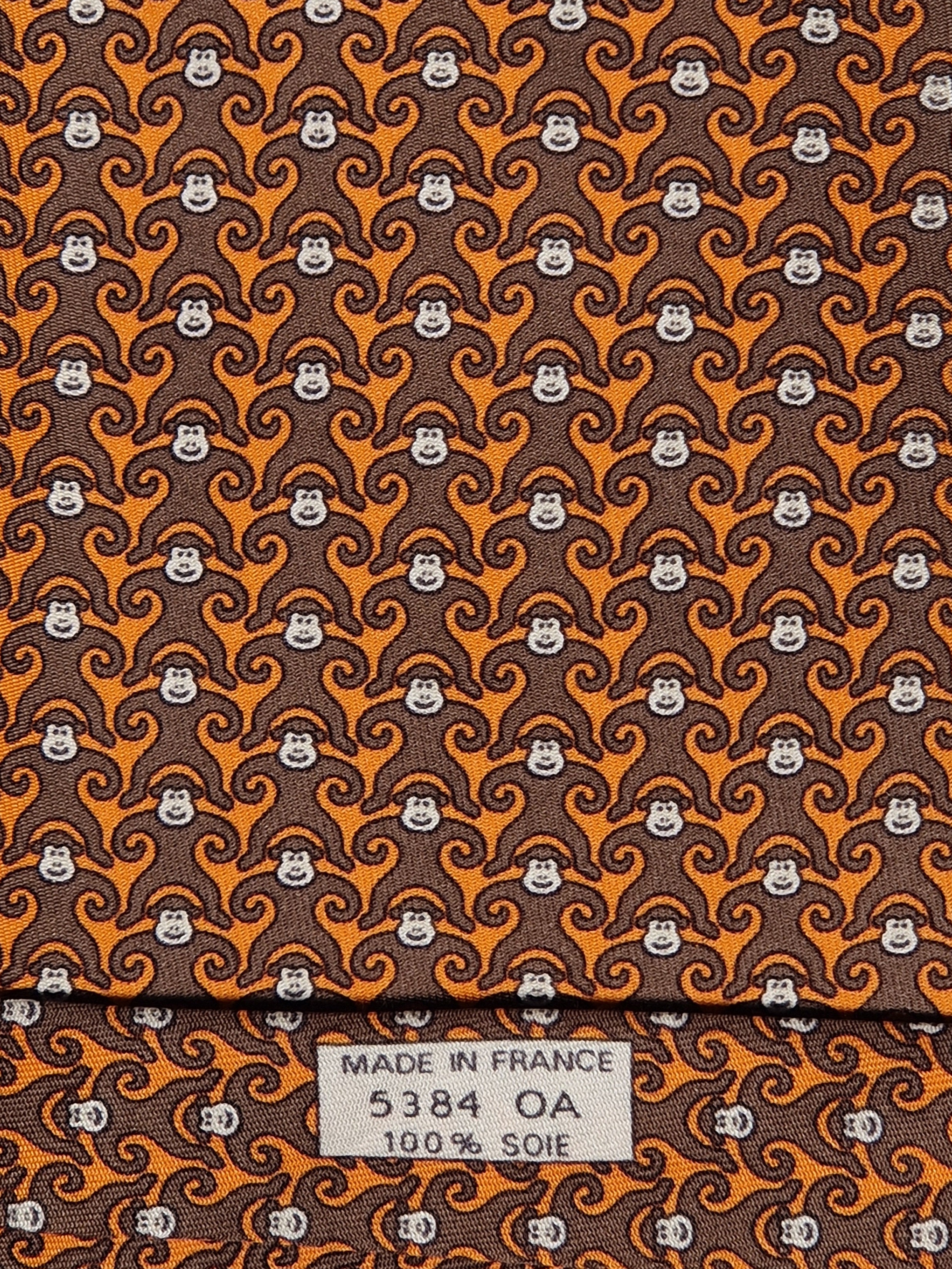 Hermès silk tie orange and brown monkey pattern 5384 oa