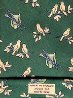 007593 Hermès tie green Bird and instruments 7593 SA