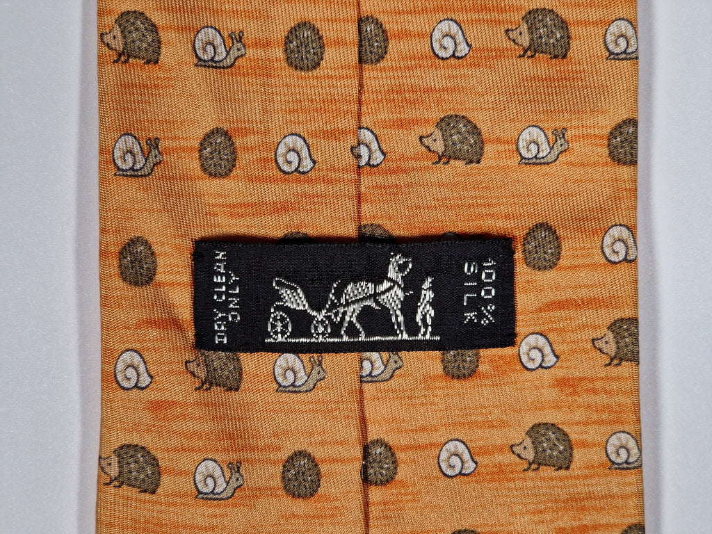 Hermès silk tie orange hedgehog and snail whimsical pattern 7850 UA