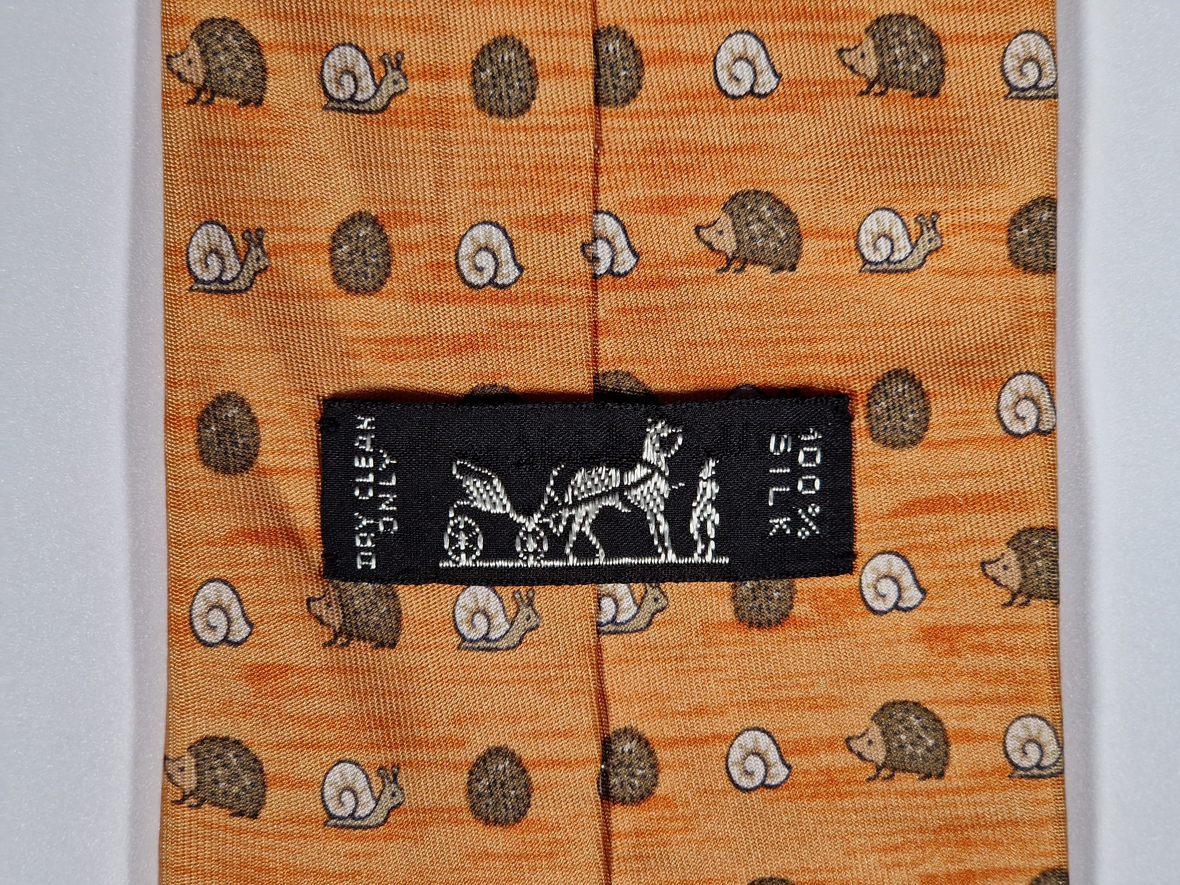 Hermès silk tie orange hedgehog and snail whimsical pattern 7850 UA